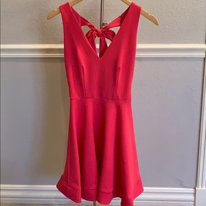 Hot pink dress with bow in the back.